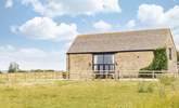 A farm fence separates the courtyard from the surrounding fields, providing unobstructed views across this rural idyll. - Thumbnail Image