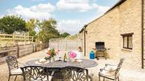 The charming outdoor space, ideal for evening drinks on a sunny day (please note, the barbecue provided is charcoal).