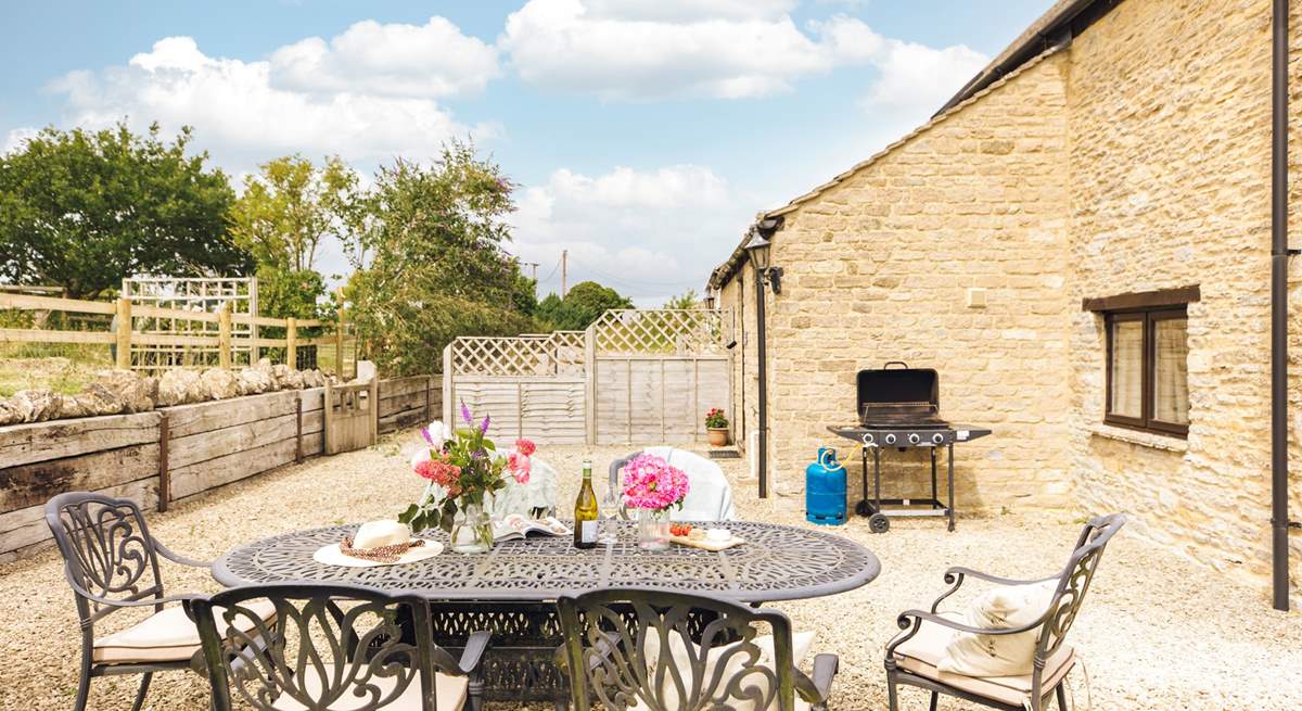 The charming outdoor space, ideal for evening drinks on a sunny day (please note, the barbecue provided is charcoal).