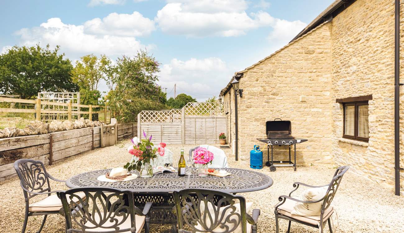 The charming outdoor space, ideal for evening drinks on a sunny day (please note, the barbecue provided is charcoal).