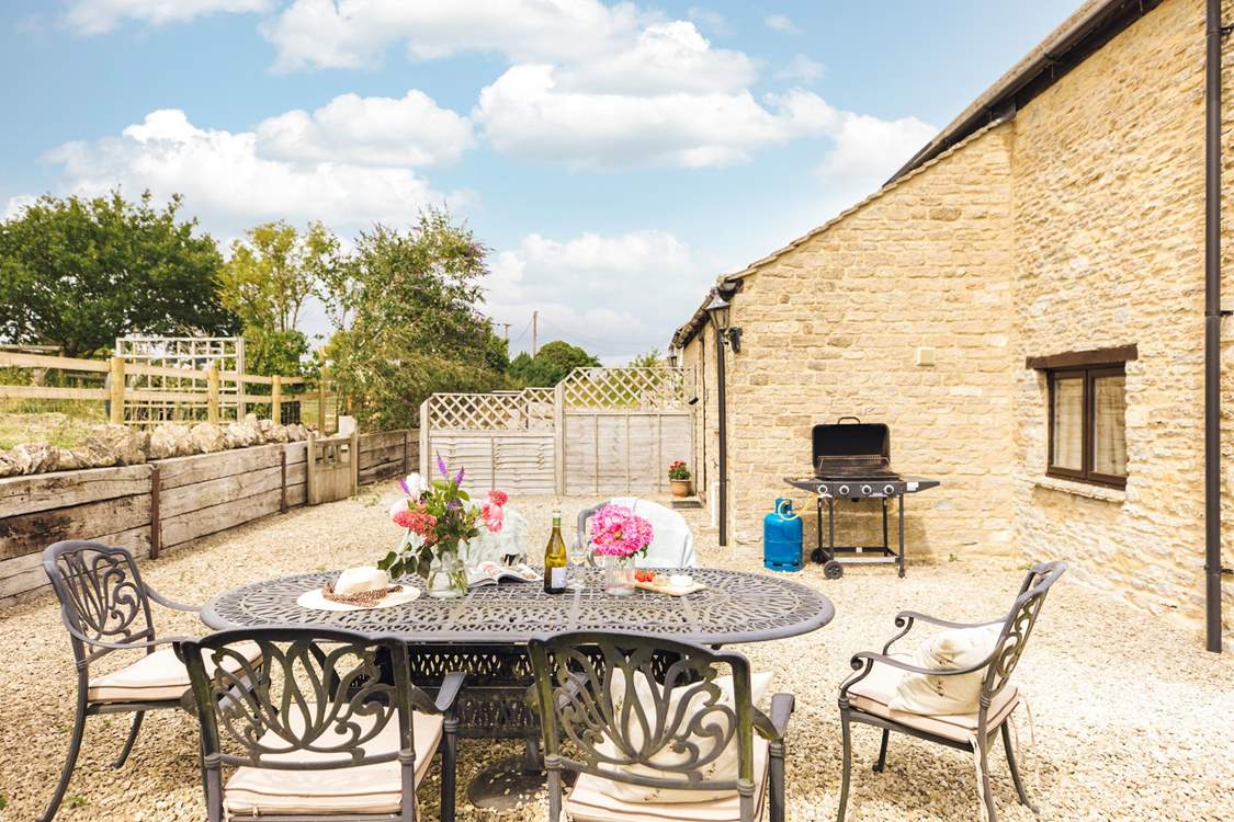 The charming outdoor space, ideal for evening drinks on a sunny day (please note, the barbecue provided is charcoal).