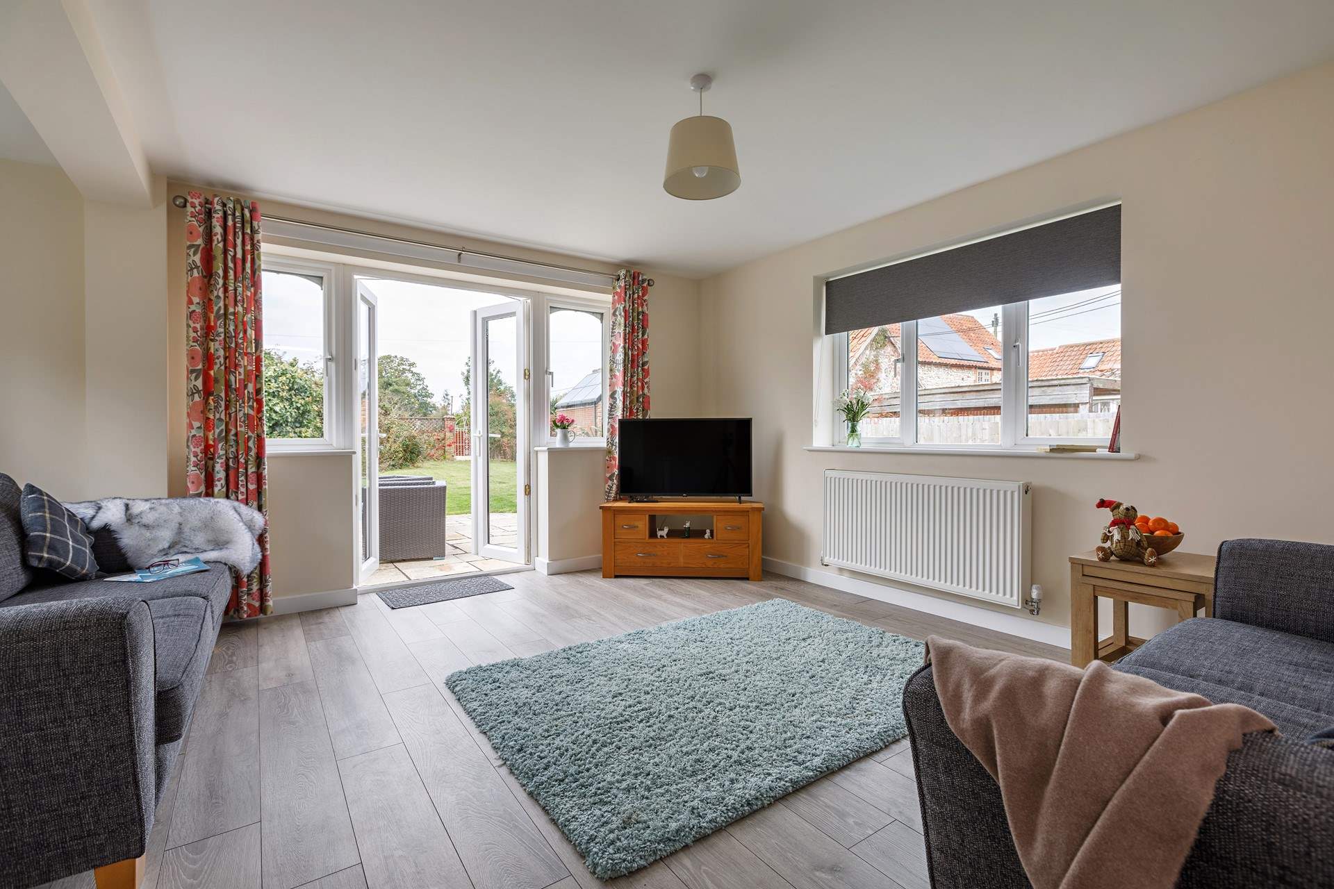 The living space opens out into the large lawned garden, perfect for children and your four-legged friends to play. 