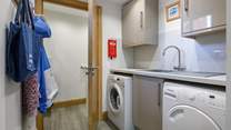 The handy utility-room has a washing machine and tumble-drier. 