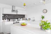 The open plan kitchen-area reflects charm and elegance, with sleek white cabinets and modern appliances.