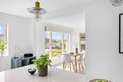 Views of this fantastic location fill the floor to ceiling window in the open plan dining-area.