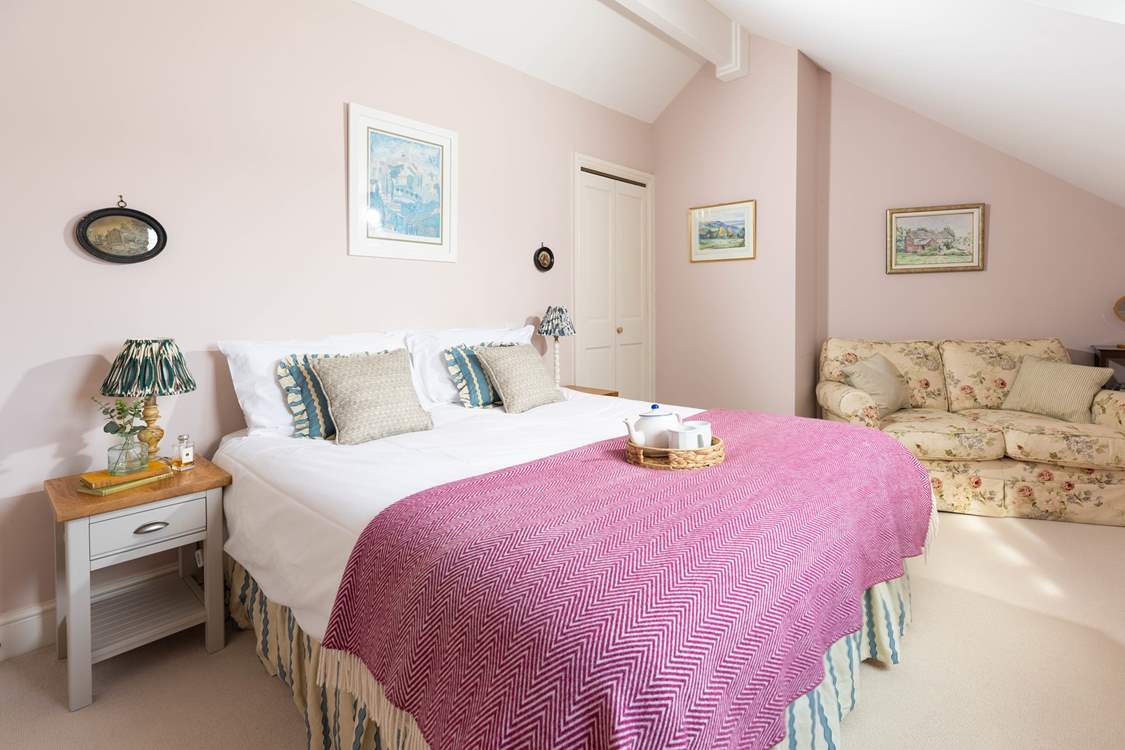 This pretty pink bedroom has a cosy reading corner (bedroom 2).