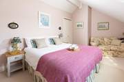 This pretty pink bedroom has a cosy reading corner (bedroom 2).
