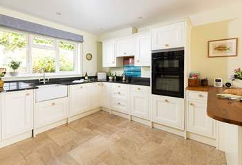 The farmhouse-style kitchen is well-equipped. 