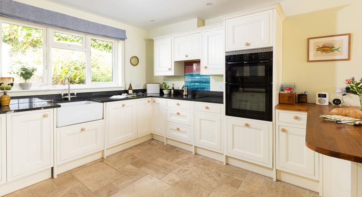 The farmhouse-style kitchen is well-equipped. 