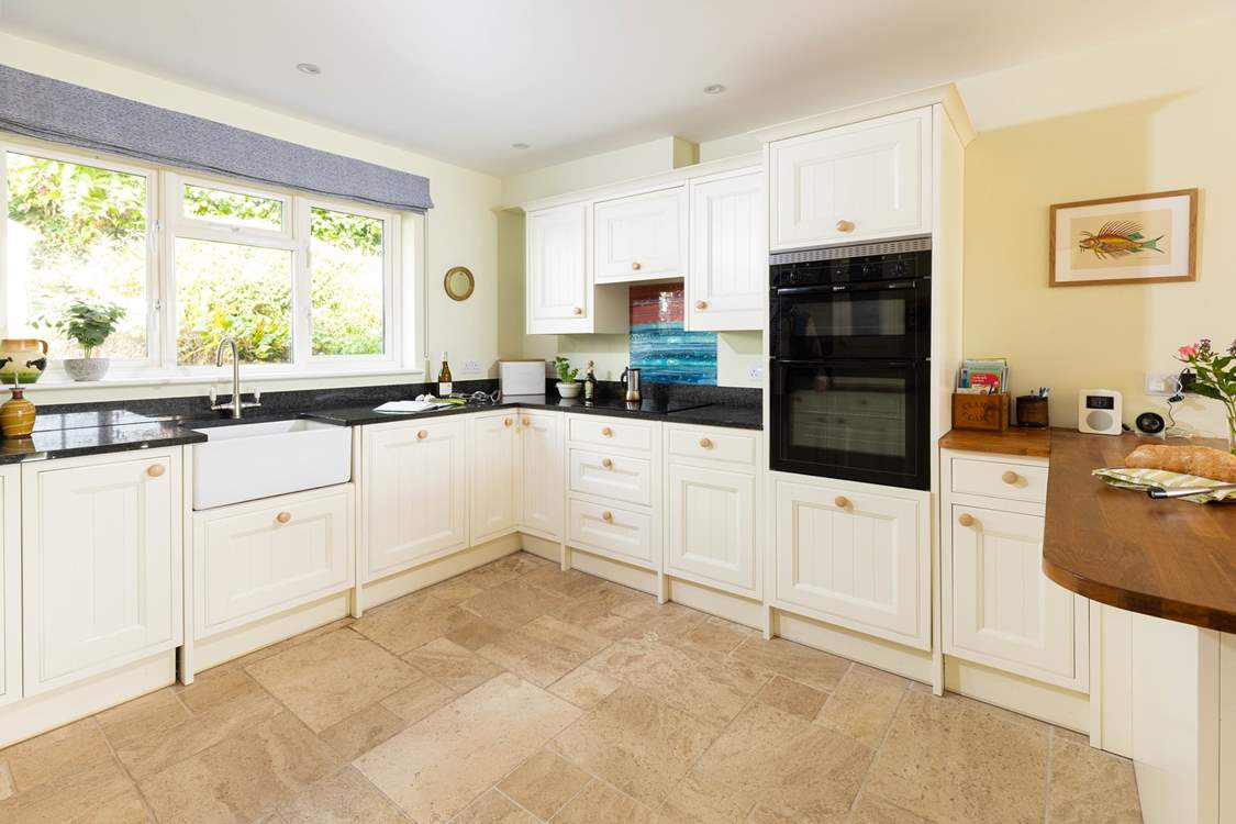 The farmhouse-style kitchen is well-equipped.