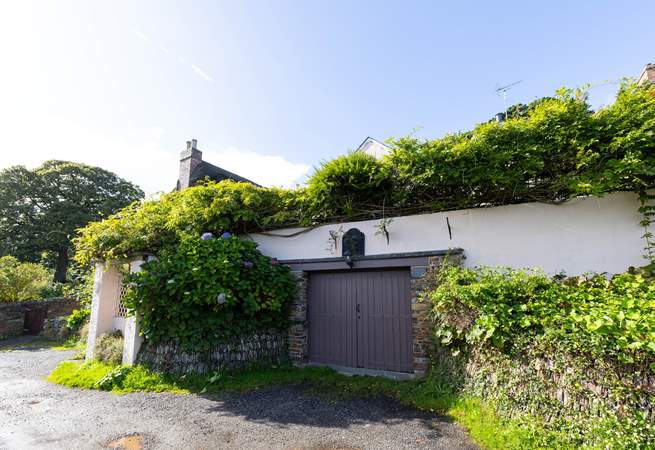 There is parking for one car, head up the steps under the wisteria to find your destination. 
