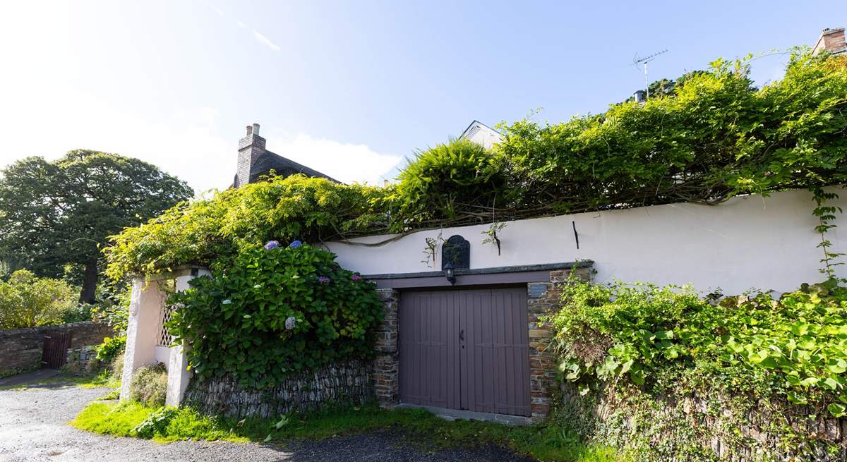 There is parking for one car, head up the steps under the wisteria to find your destination. 