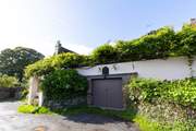 There is parking for one car, head up the steps under the wisteria to find your destination.