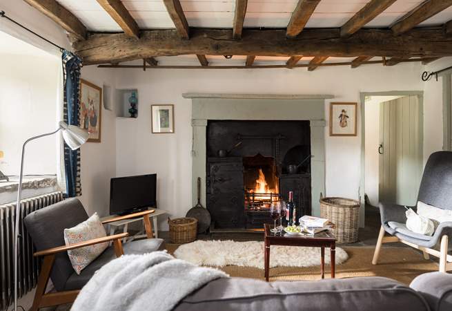 The fire crackles in the original black leaded range.