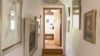 Eclectic artwork adorns the upstairs hallway.