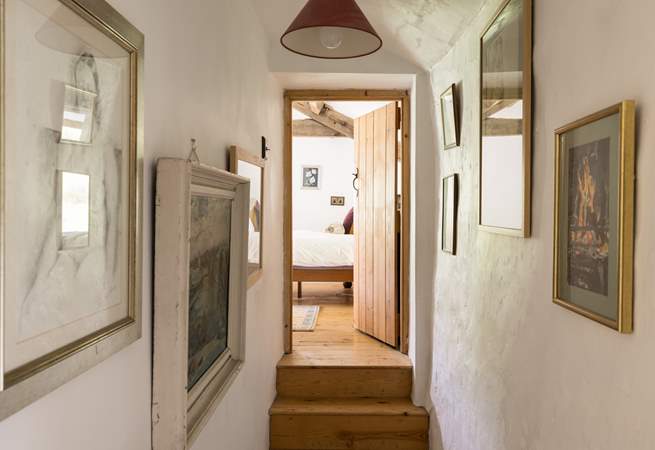 Eclectic artwork adorns the upstairs hallway.