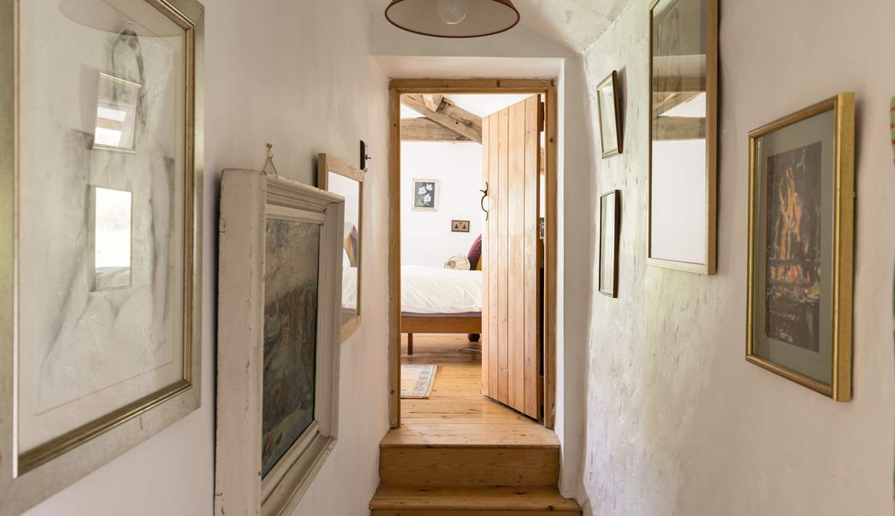 Eclectic artwork adorns the upstairs hallway.