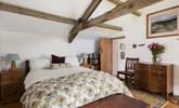 Original beams grace this cosy bedroom. - Thumbnail Image