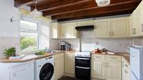 The well-equipped kitchen opens onto the garden.