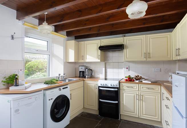 The well-equipped kitchen opens onto the garden.