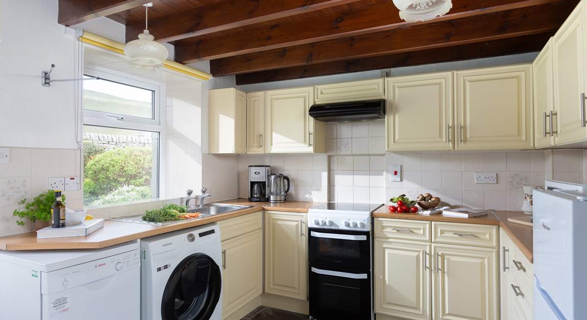 The well-equipped kitchen opens onto the garden.