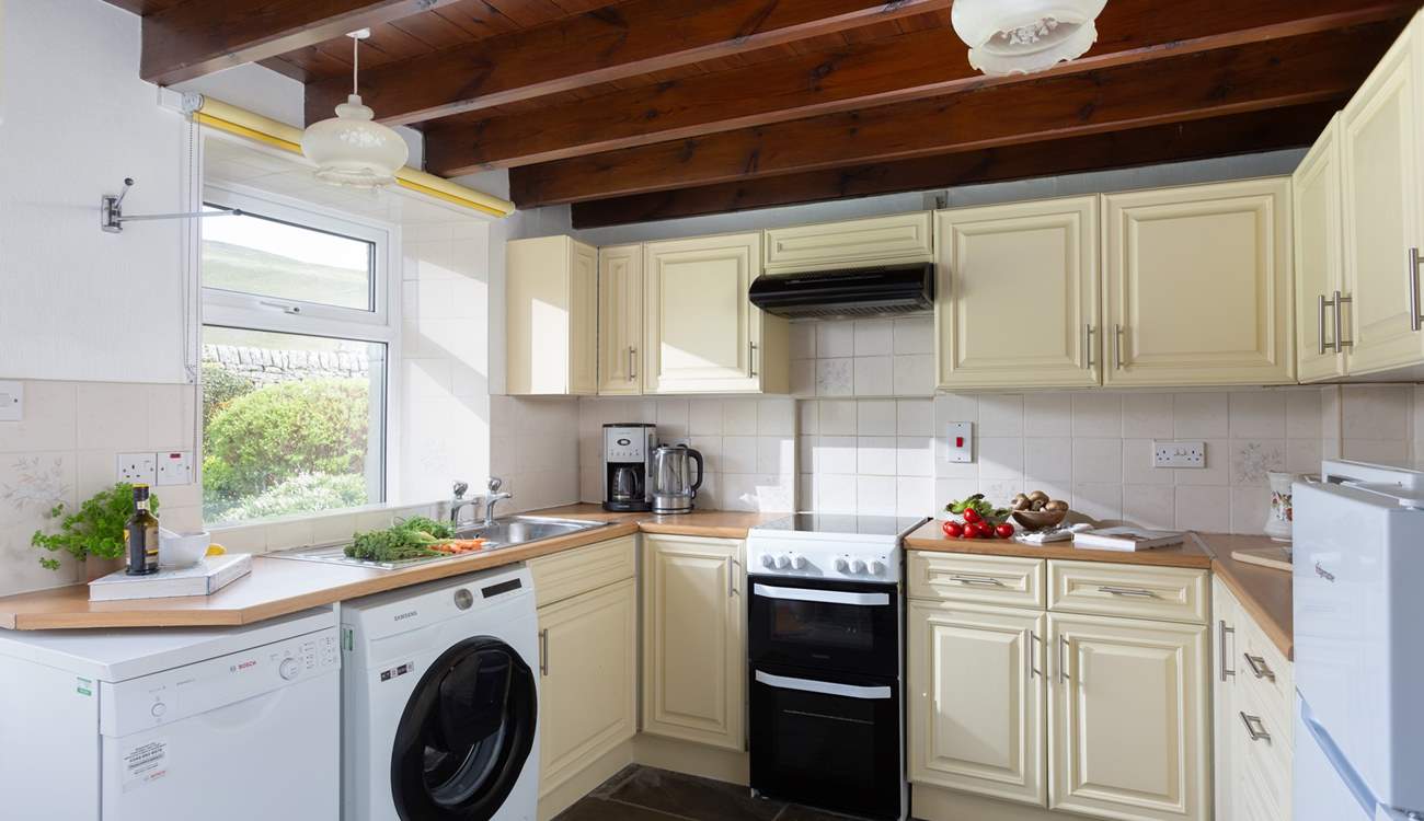 The well-equipped kitchen opens onto the garden.