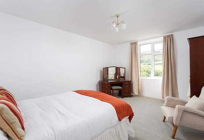 Another spacious bedroom with views.