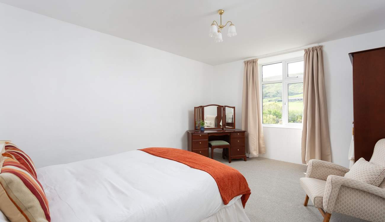 Another spacious bedroom with views.