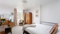 This spacious bedroom could be yours for your stay.