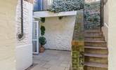 Steps lead down from the private parking area to the enclosed courtyard. - Thumbnail Image