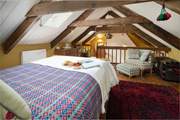 Climb the wooden stairs to the mezzanine bedroom for a hushed night's sleep. Watch out for the low ceilings and wooden beams.