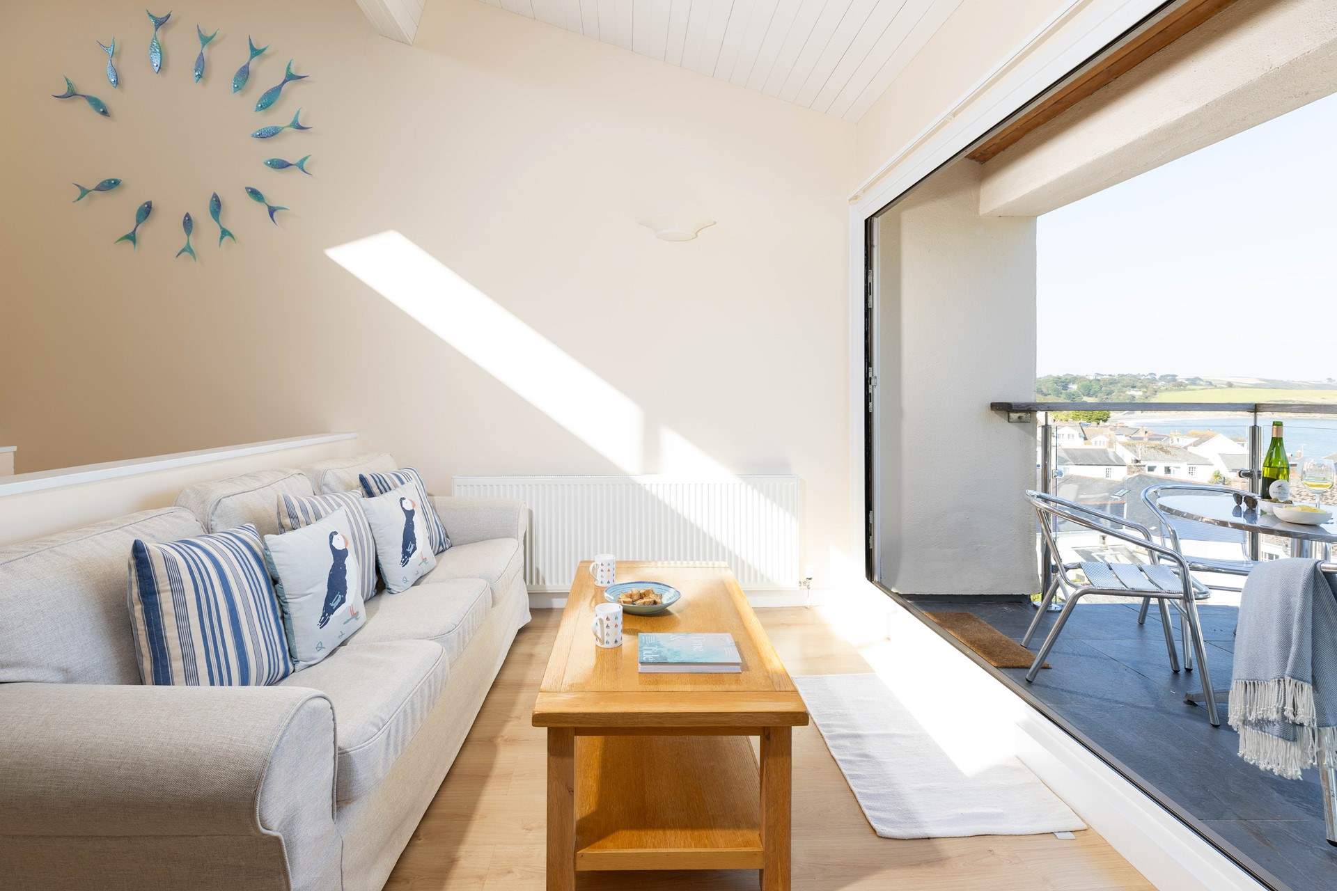 The large balcony doors open up to create a lovely space to enjoy the view.