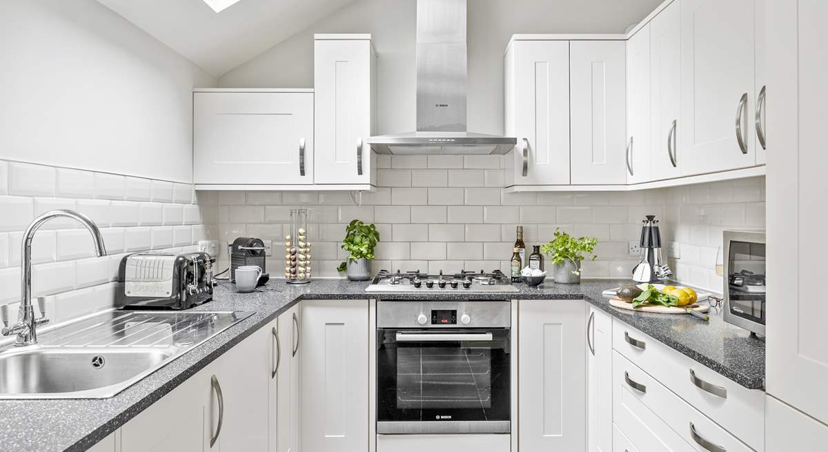 With its white and chrome cupboards the kitchen is as shiny as a new pin.