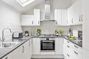 With its white and chrome cupboards the kitchen is as shiny as a new pin.