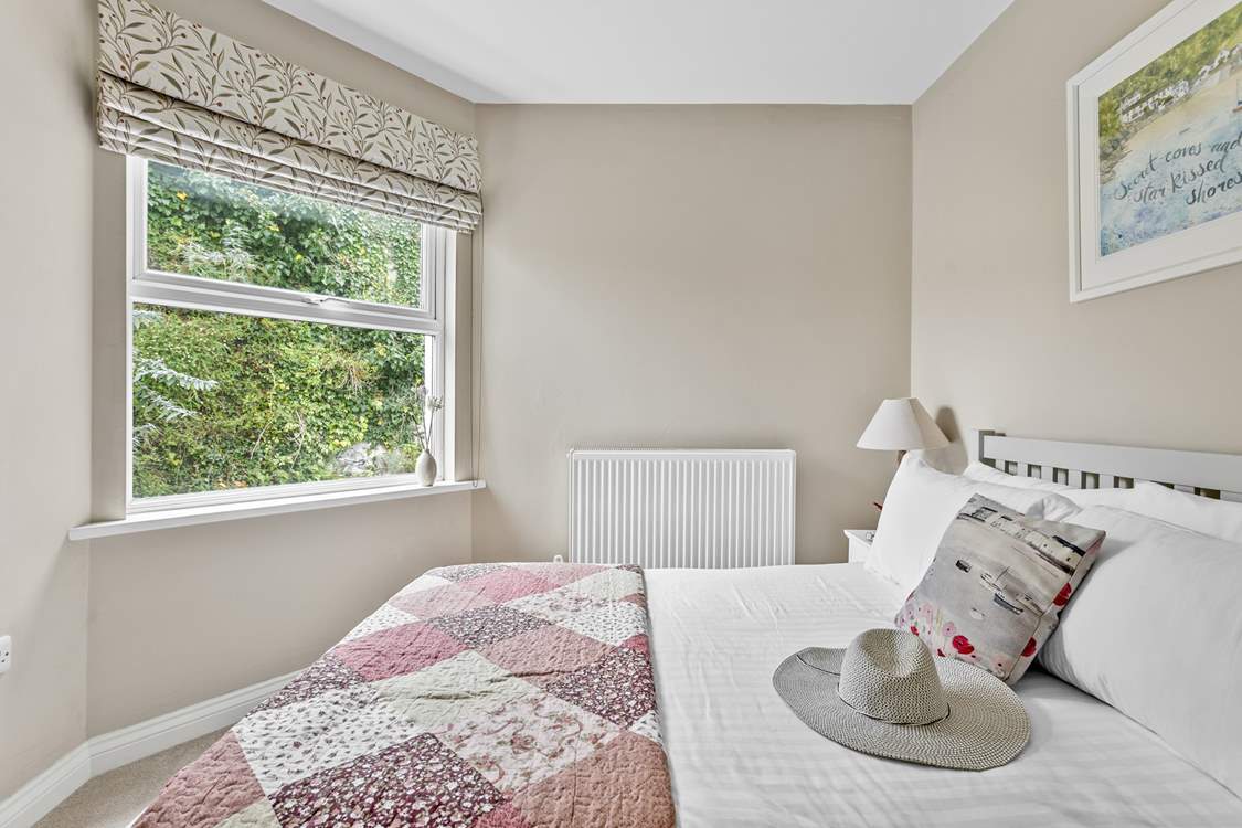A pretty patchwork quilt dresses the bed.