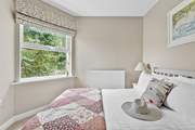 A pretty patchwork quilt dresses the bed.