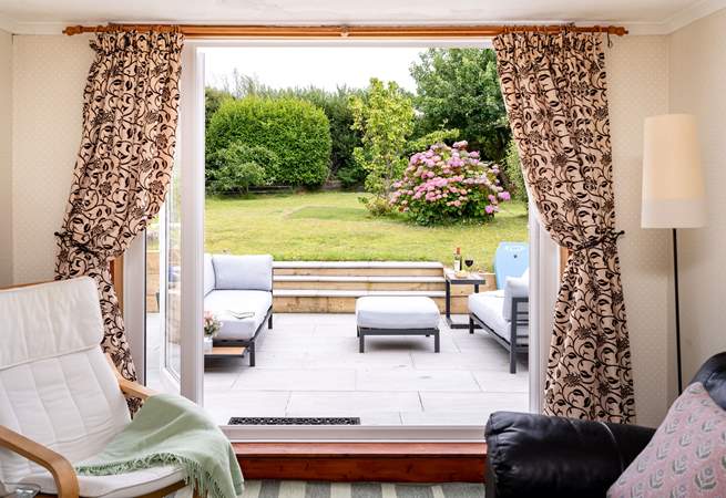 Take in the garden views from the sitting-room. 
