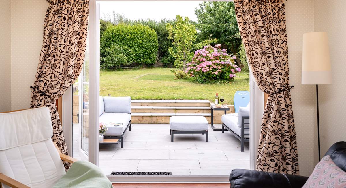 Take in the garden views from the sitting-room. 