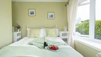 Soothing hues in the spacious king room on the ground floor. Enjoy slow holiday mornings watching television in bed. 