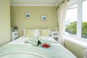 Soothing hues in the spacious king room on the ground floor. Enjoy leisurely holiday mornings watching television in bed.