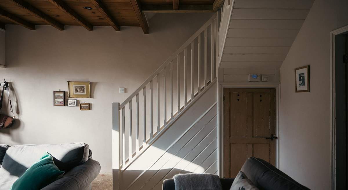 The stairs from the sitting-room lead up to the bedrooms and bathroom.