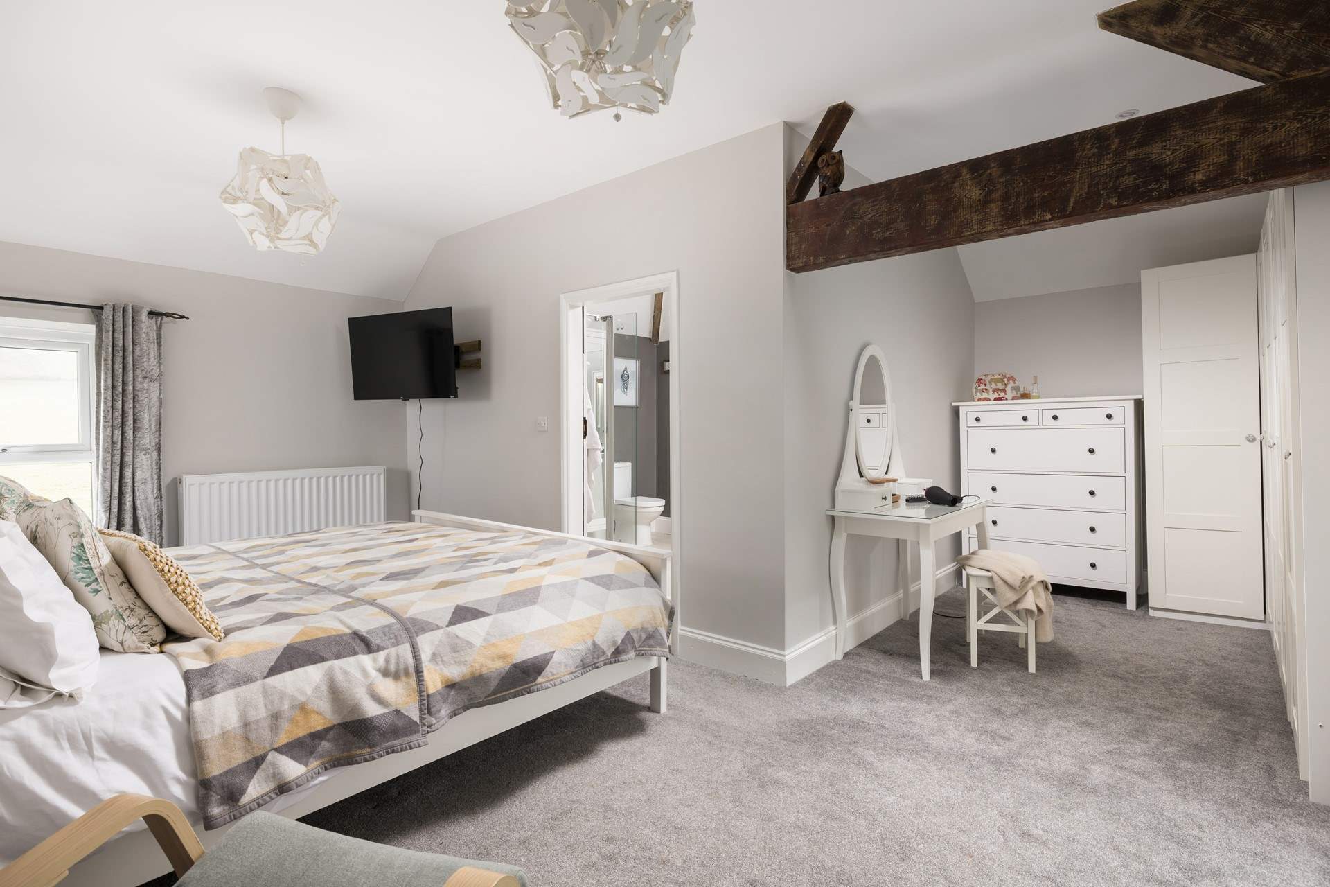 This spacious bedroom offers a dressing-area and en suite.