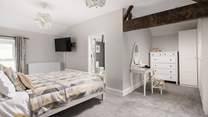 This spacious bedroom offers a dressing-area and en suite.