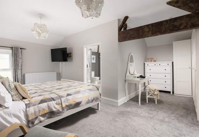 This spacious bedroom offers a dressing-area and en suite.