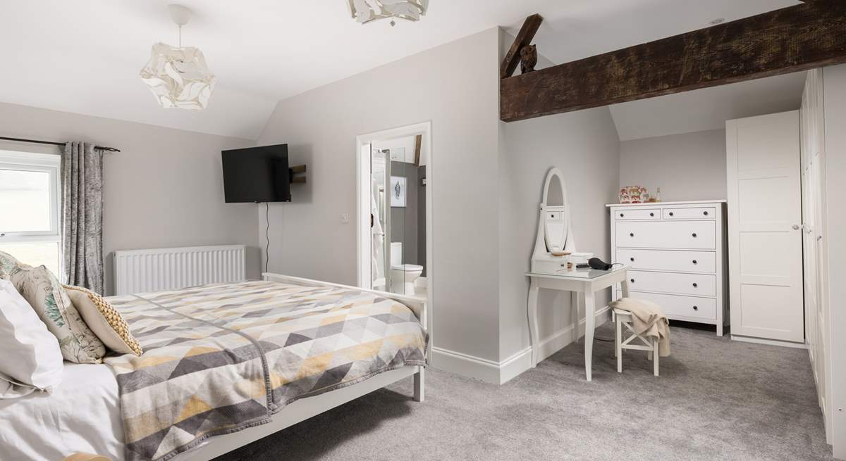 This spacious bedroom offers a dressing-area and en suite.