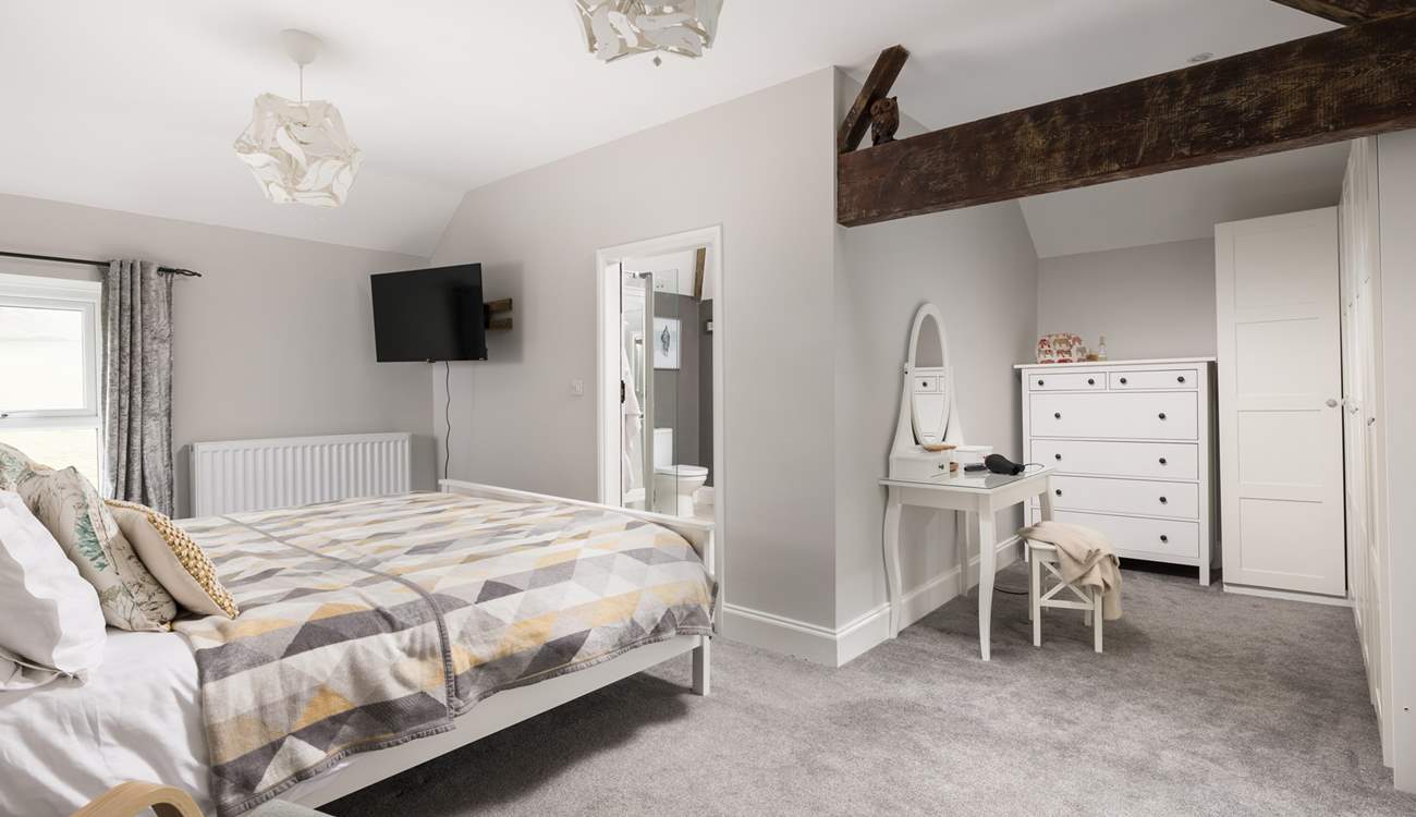 This spacious bedroom offers a dressing-area and en suite.