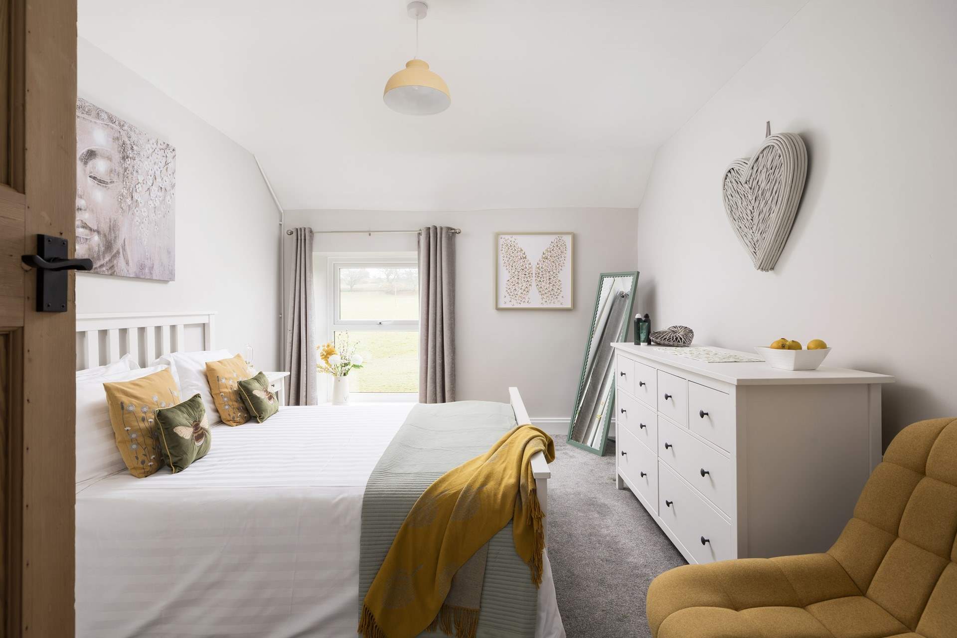 This pretty bedroom looks out over fields.