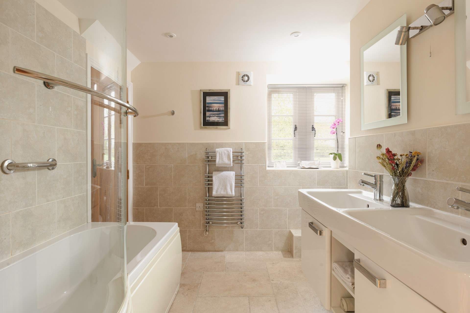 The family bathroom has two sinks and a bath for those long soaks.