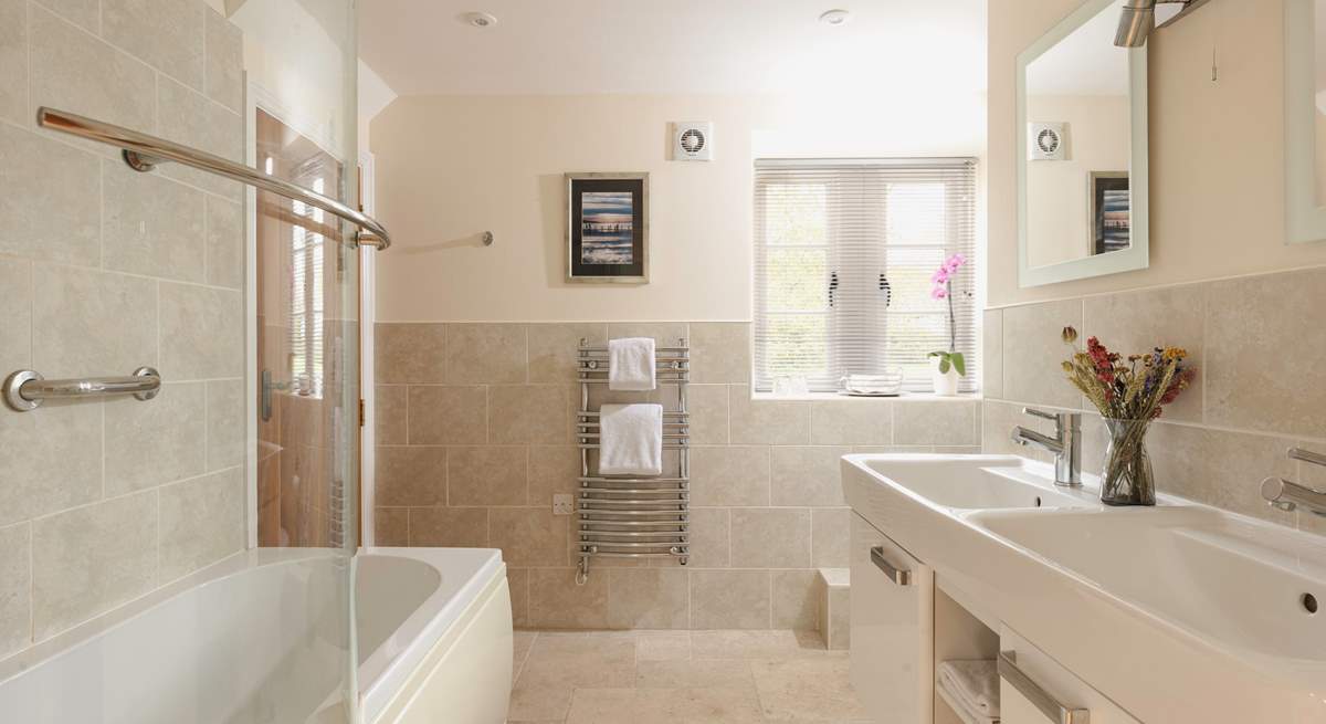 The family bathroom has two sinks and a bath for those long soaks.