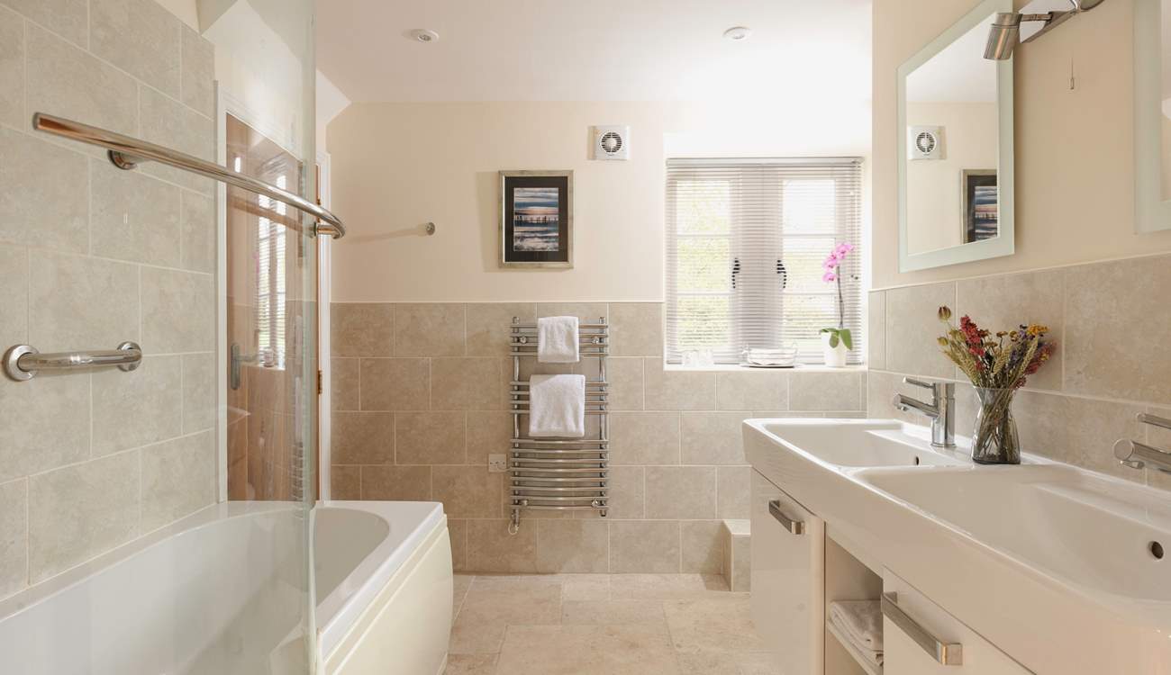 The family bathroom has two sinks and a bath for those long soaks.